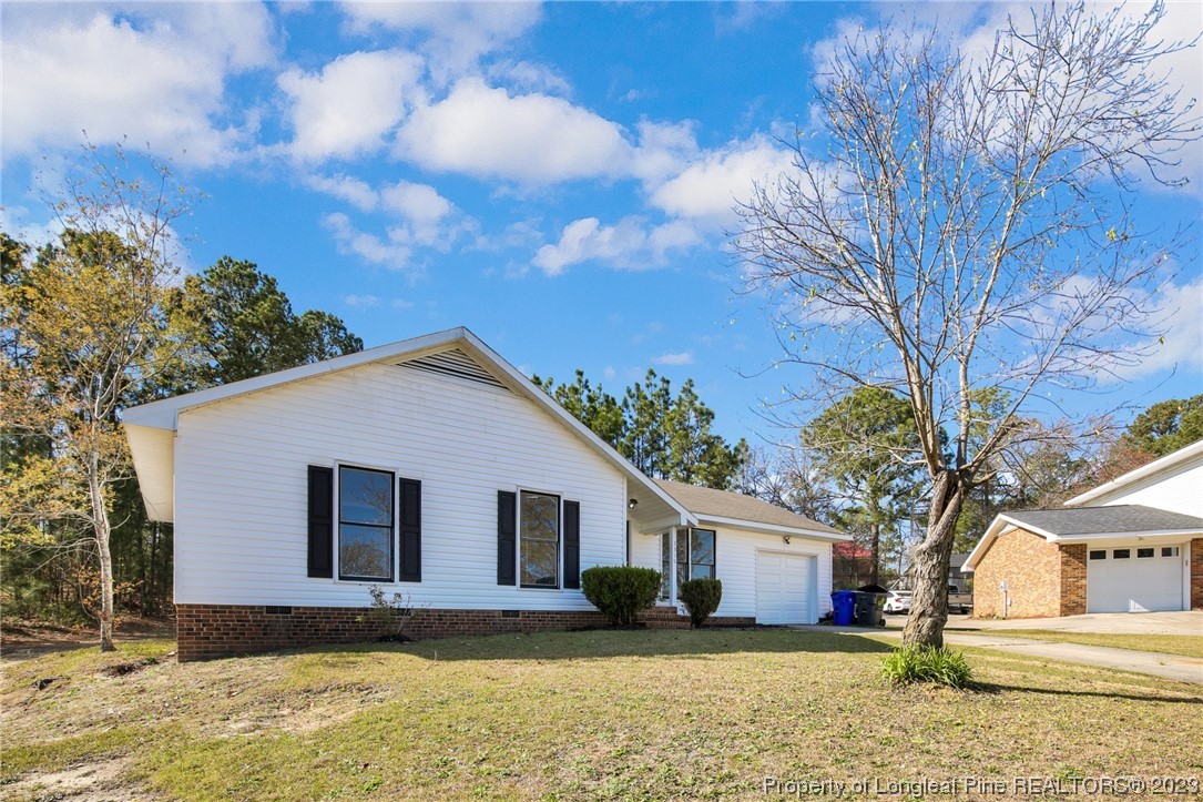3319 Hedgemoor Circle Spring Lake, NC 28390 - Photo 2 of 30 a white house that has a tree in front of it