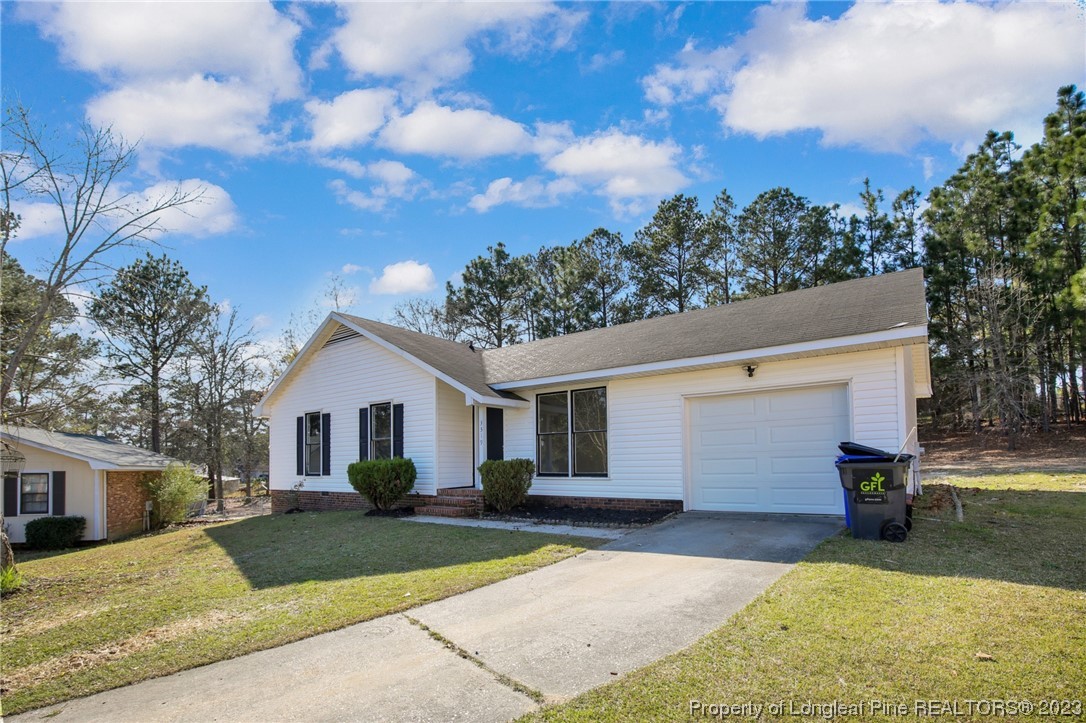 3319 Hedgemoor Circle Spring Lake, NC 28390 - Photo 3 of 30 a view of a yard in front of a house with a large tree