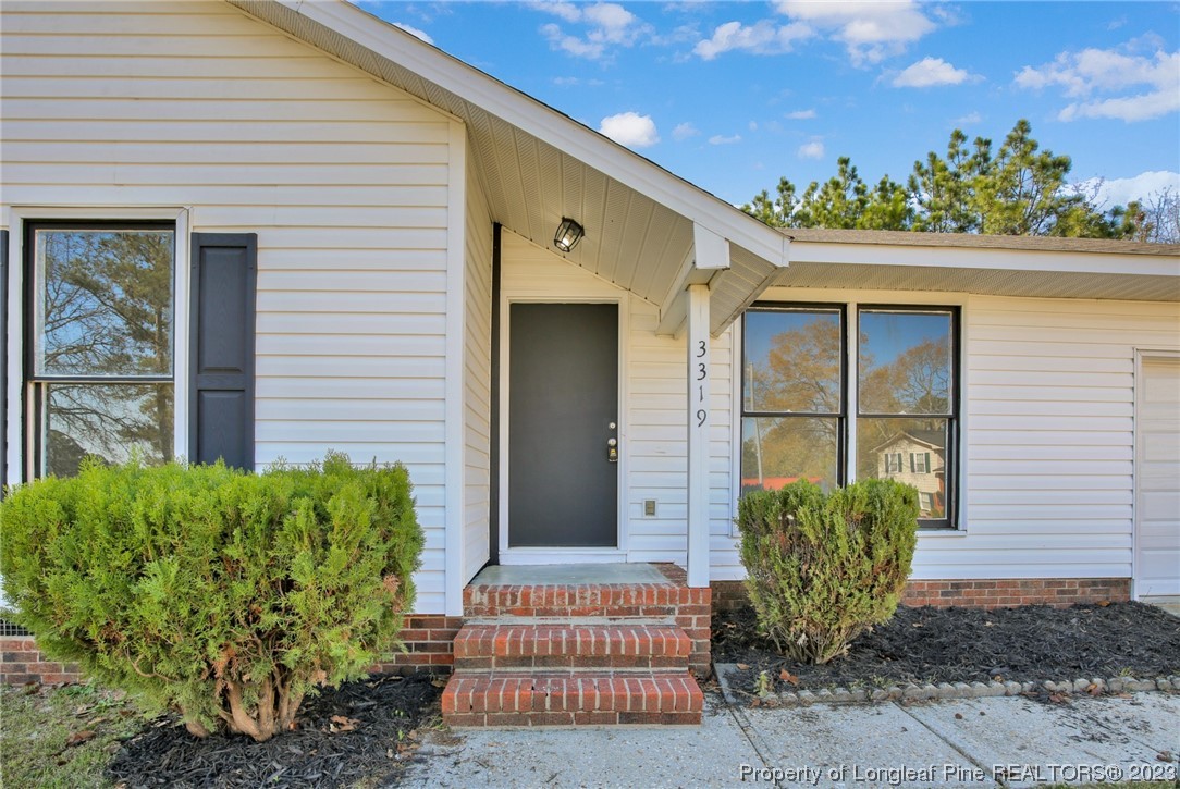 3319 Hedgemoor Circle Spring Lake, NC 28390 - Photo 4 of 30 a front view of a house with a garden