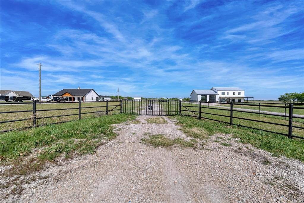 2641 Bode Road West, TX 76691 - Photo 2 of 18 View of gravel driveway featuring a gate and a gated entry