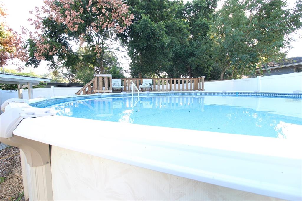 5910 Indian Hill Road Orlando, FL 32808 - Photo 11 of 12 a view of a swimming pool with an outdoor seating