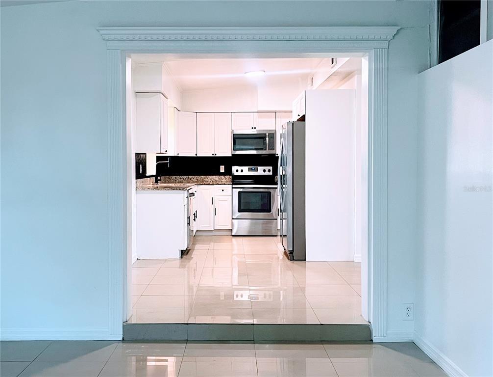 5910 Indian Hill Road Orlando, FL 32808 - Photo 4 of 12 a kitchen with stainless steel appliances a refrigerator and a stove