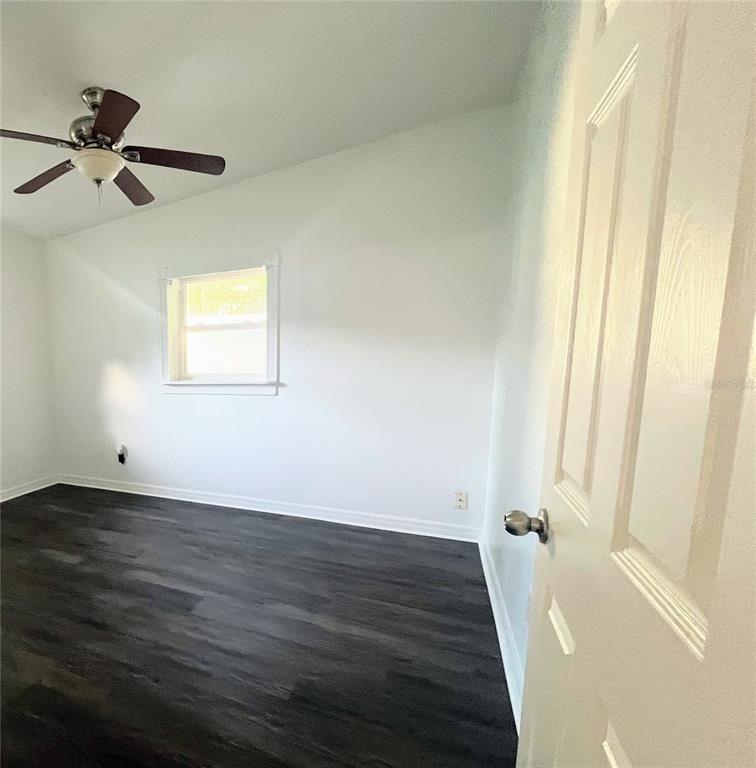 5910 Indian Hill Road Orlando, FL 32808 - Photo 7 of 12 a view of a room with wooden floor and window