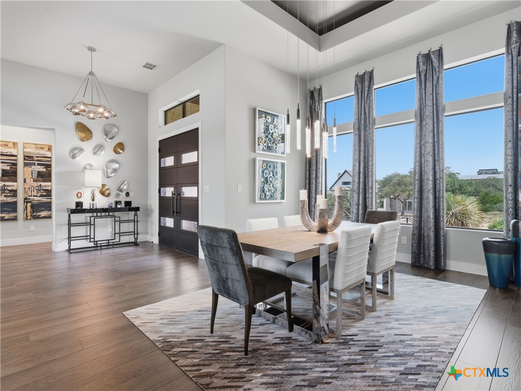 5913 Verden Ridge New Braunfels, TX 78132 - Photo 4 of 48 a view of a dining room with furniture window and wooden floor