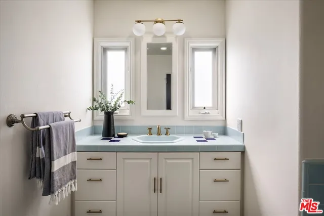 a bathroom with a sink and a mirror