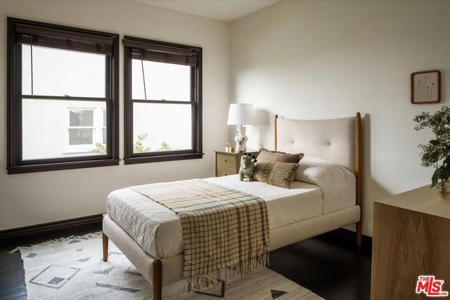 a bedroom with a bed and a large window