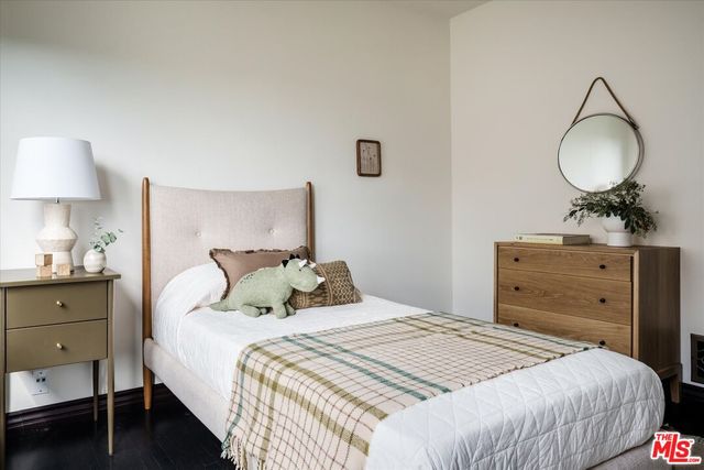 a bedroom with a bed and a dresser