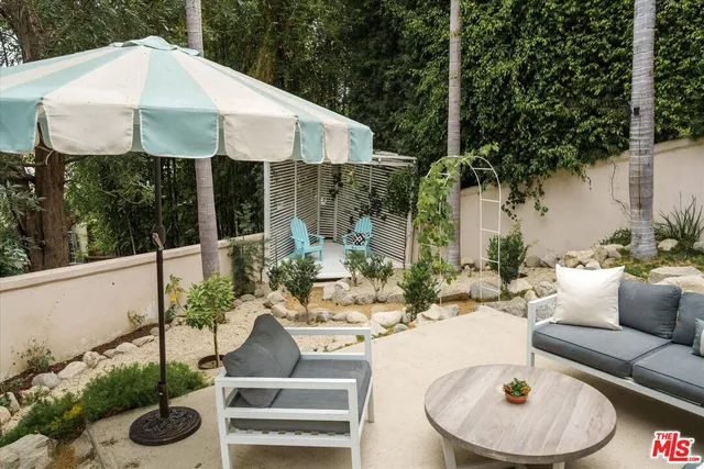 a view of a patio with couches table and chairs potted plants