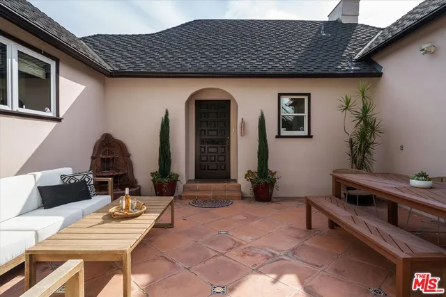 a backyard of a house with table and chairs