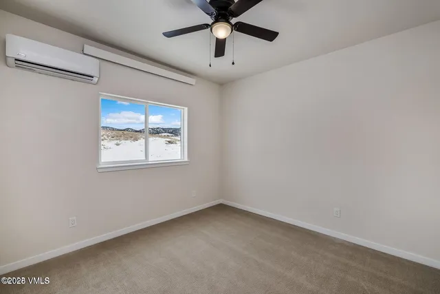 a view of empty room with ceiling fan