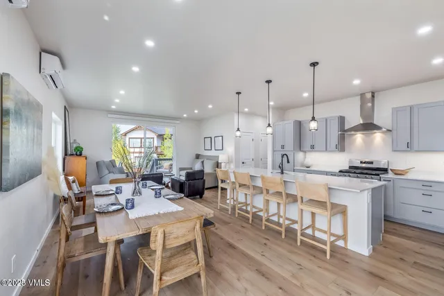a large kitchen with a table and chairs