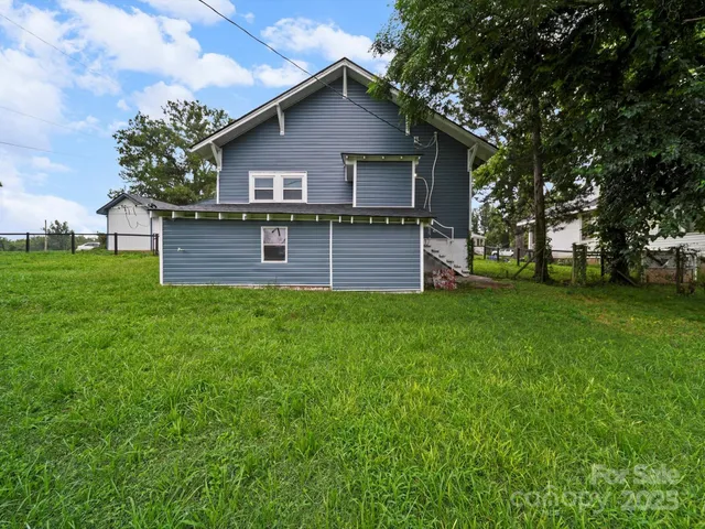 a front view of house with yard and trees