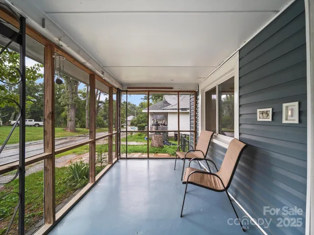 a view of a porch with furniture and wooden floor