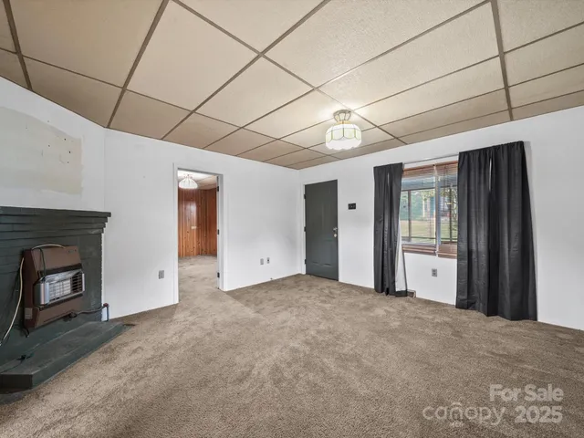 a view of a livingroom with an empty space and a fireplace