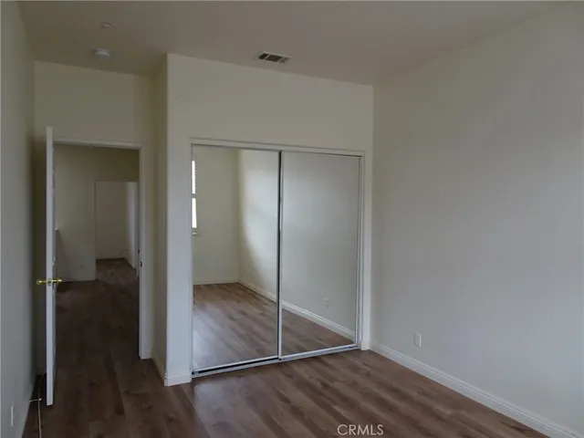 an empty room with wooden floor