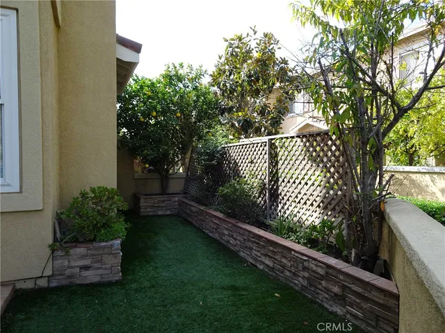 a view of garden with wooden fence