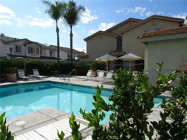 a view of swimming pool with outdoor seating and a garden