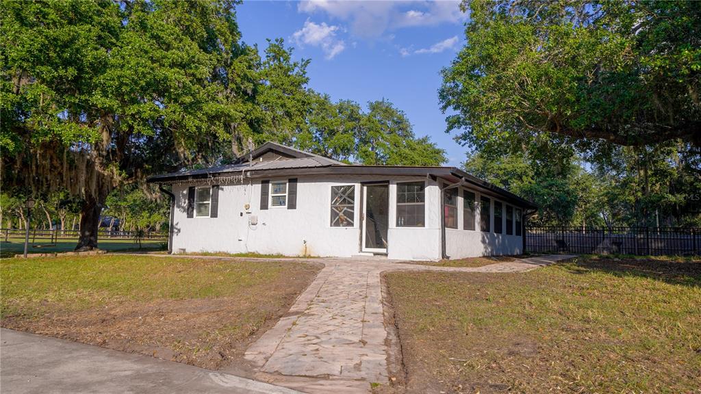 5160 Haywood Ruffin Road St. Cloud, FL 34771 - Photo 11 of 39 a front view of a house with a yard