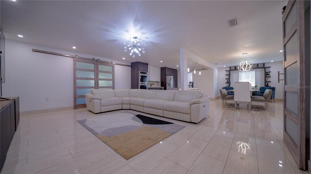 5160 Haywood Ruffin Road St. Cloud, FL 34771 - Photo 17 of 39 a living room with furniture and a chandelier