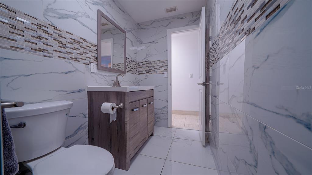 5160 Haywood Ruffin Road St. Cloud, FL 34771 - Photo 30 of 39 a bathroom with a sink toilet and shower