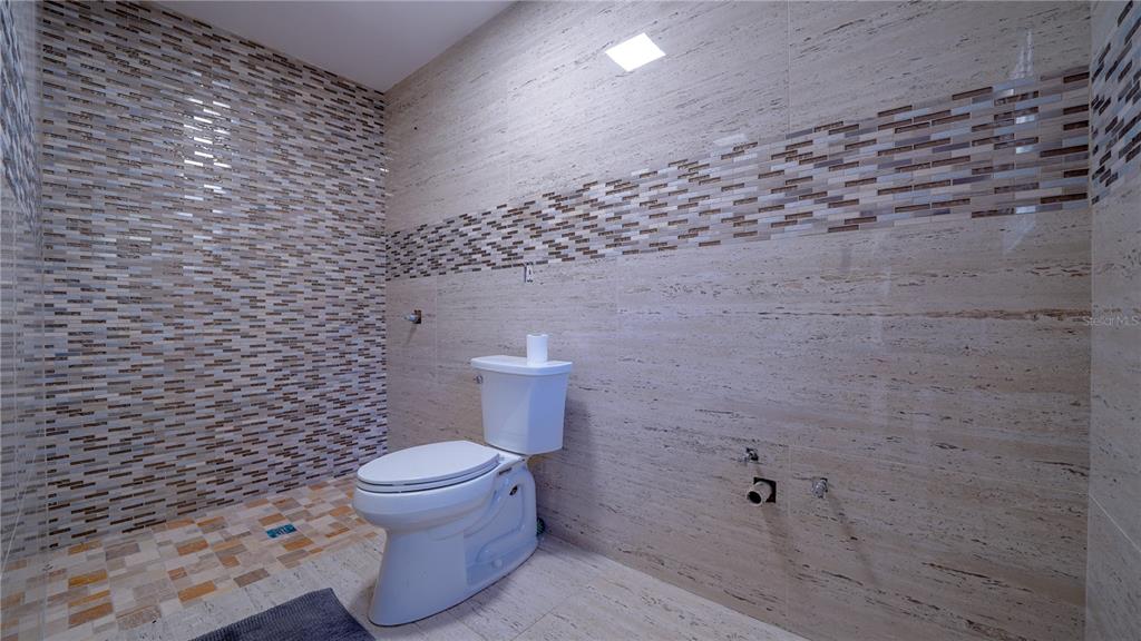 5160 Haywood Ruffin Road St. Cloud, FL 34771 - Photo 32 of 39 a bathroom with a toilet and a shower