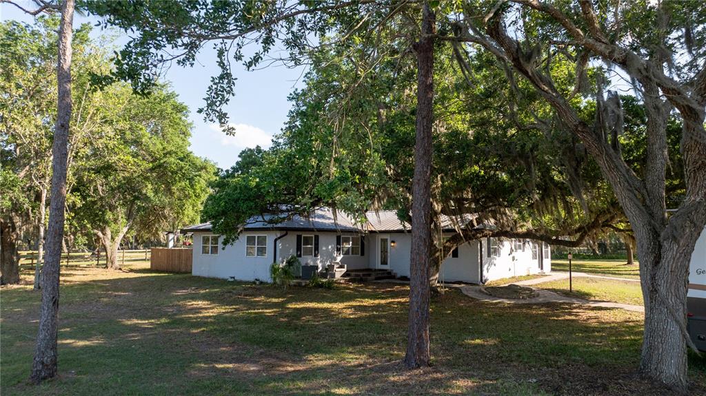 5160 Haywood Ruffin Road St. Cloud, FL 34771 - Photo 7 of 39 a front view of a house with a garden