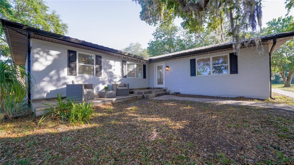 5160 Haywood Ruffin Road St. Cloud, FL 34771 - Photo 9 of 39 a backyard of a house with yard and outdoor seating