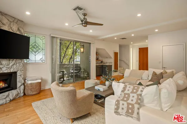a living room with furniture fireplace and a flat screen tv