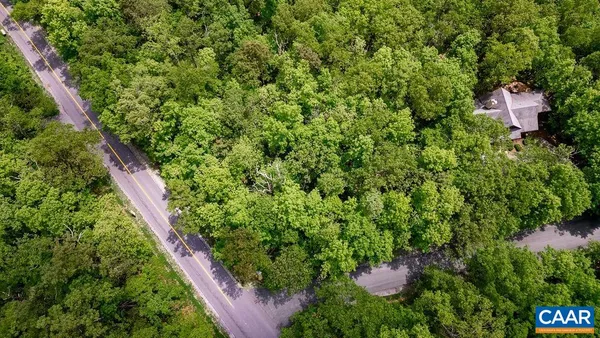 an aerial view of a house with a tree