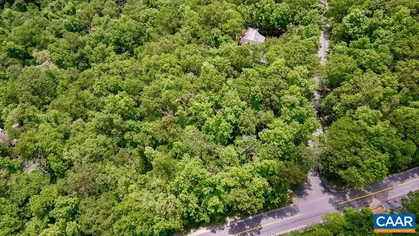 a sign broad in front of the red wall