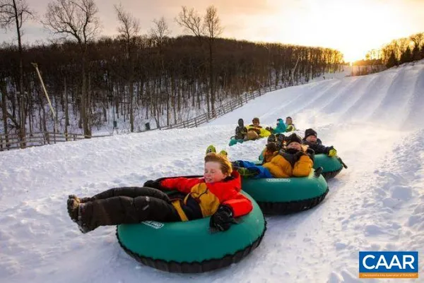 a backyard of a house with lots of green space and fountain