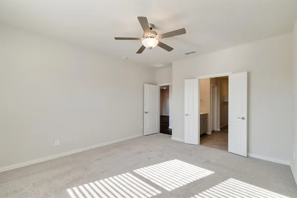 a view of a livingroom with a ceiling fan and window
