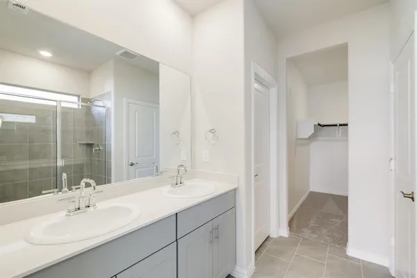 a bathroom with a sink double vanity and a mirror