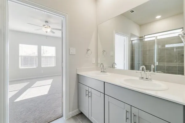 a bathroom with a sink double vanity and a mirror