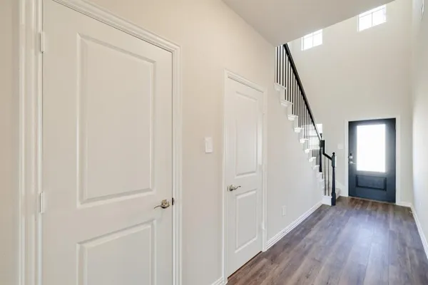 a view of a hallway with wooden floor