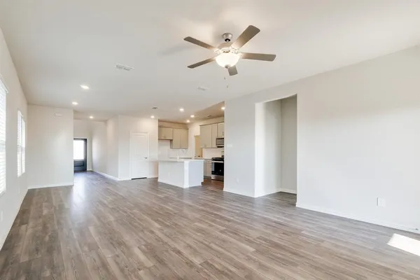 a view of a kitchen with wooden floor and a window