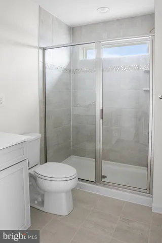 a bathroom with a toilet and a shower
