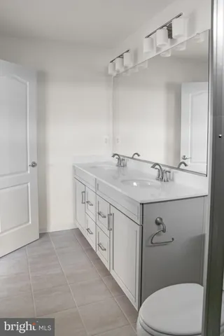 a bathroom with a sink a toilet and mirror