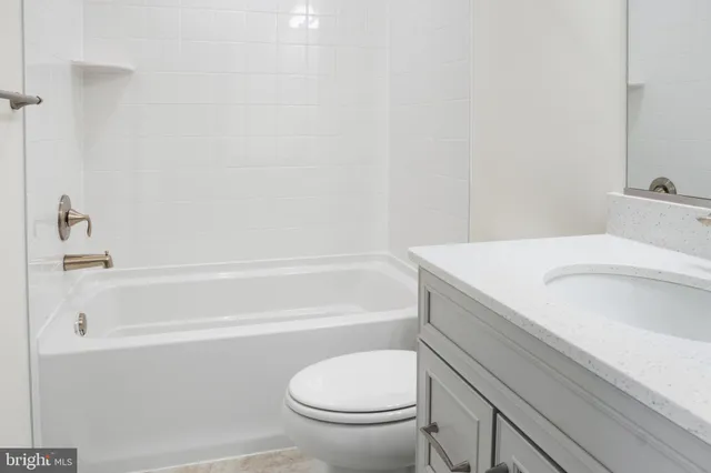 a bathroom with a sink a toilet and a bathtub