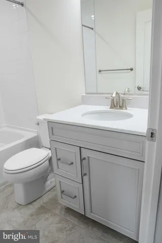 a bathroom with a sink a toilet and bathtub