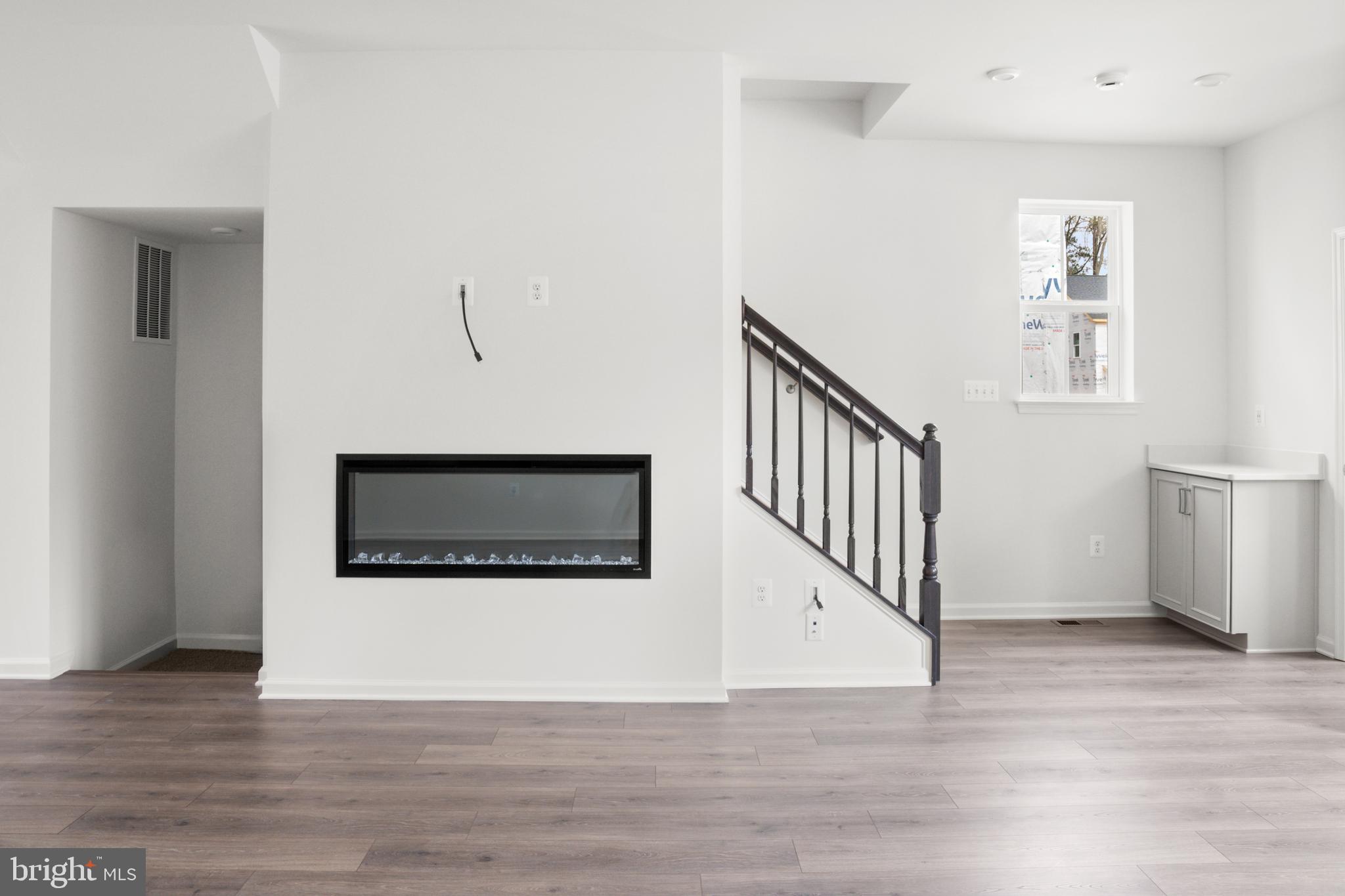 8226 Longford Road Glen Burnie, MD 21061 - Photo 10 of 31 a view of a hallway with wooden floor and staircase