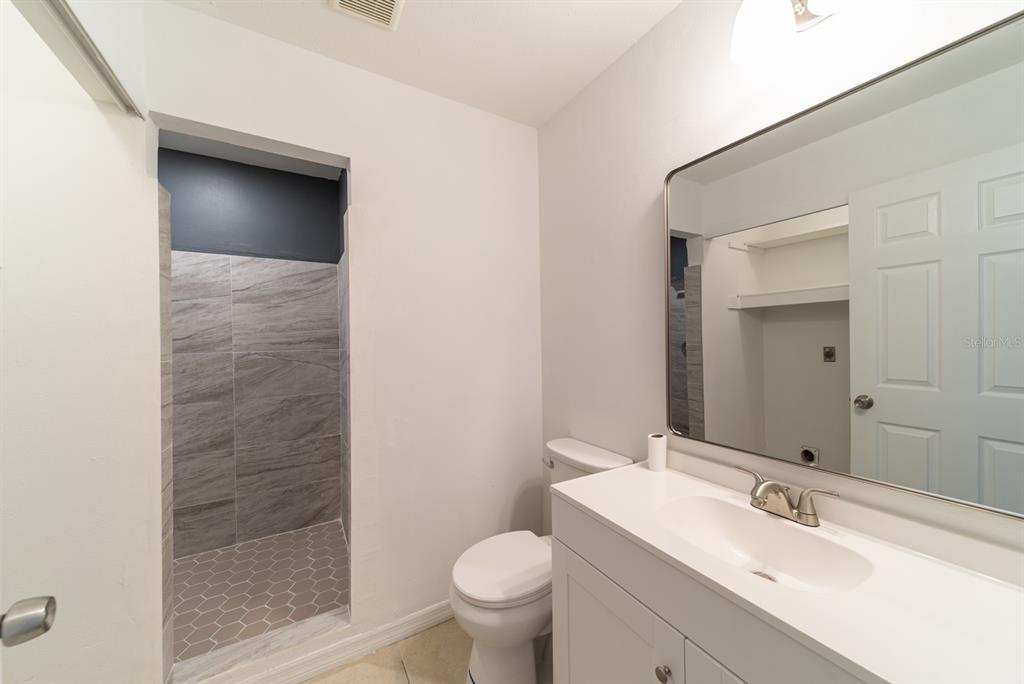 6345 Hatcher Road Lakeland, FL 33811 - Photo 12 of 41 a bathroom with a sink toilet and shower