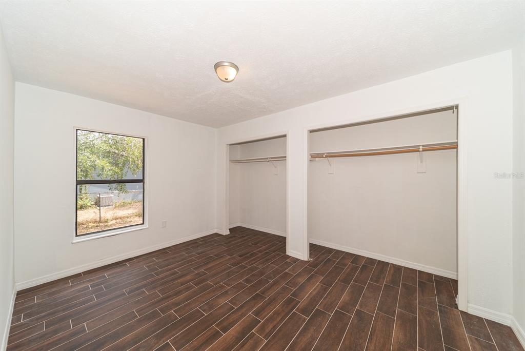 6345 Hatcher Road Lakeland, FL 33811 - Photo 15 of 41 an empty room with wooden floor and windows