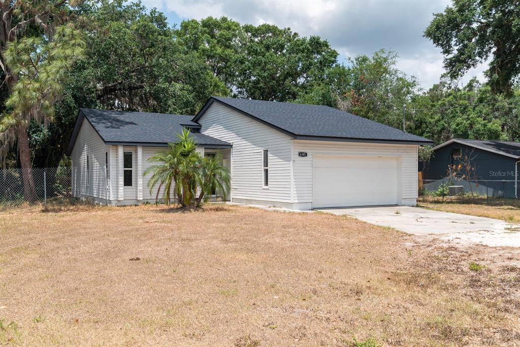 6345 Hatcher Road Lakeland, FL 33811 - Photo 17 of 41 a front view of a house with a yard and garage