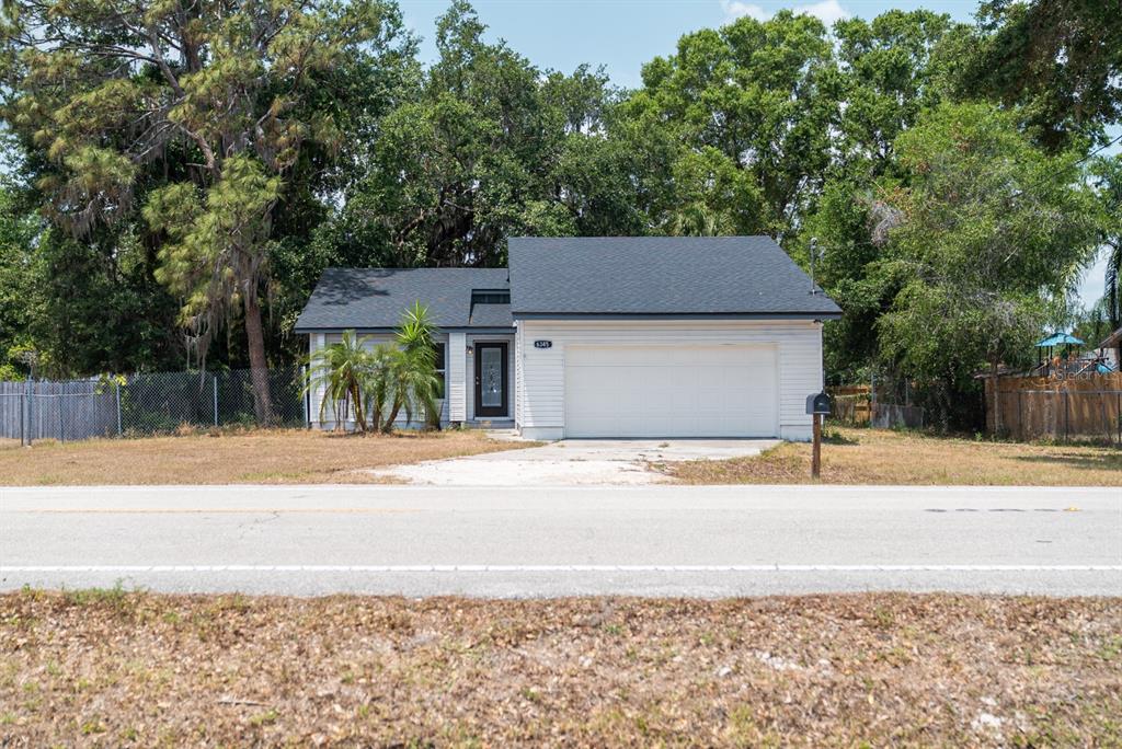 6345 Hatcher Road Lakeland, FL 33811 - Photo 2 of 41 a house that has a tree in front of it
