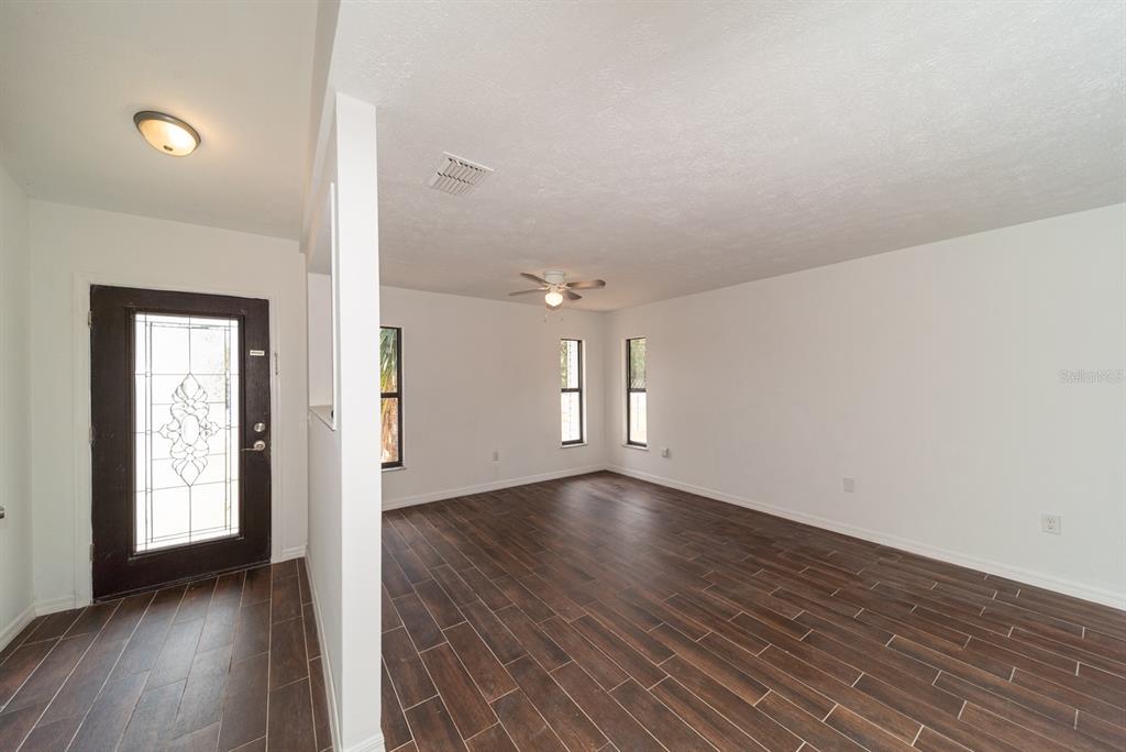 6345 Hatcher Road Lakeland, FL 33811 - Photo 25 of 41 an empty room with wooden floor and windows