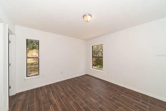 a view of a room with wooden floor and cabinet