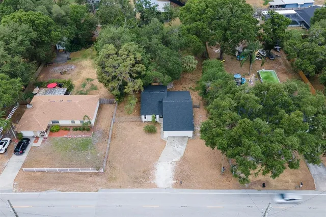 a view of house with a garden and trees