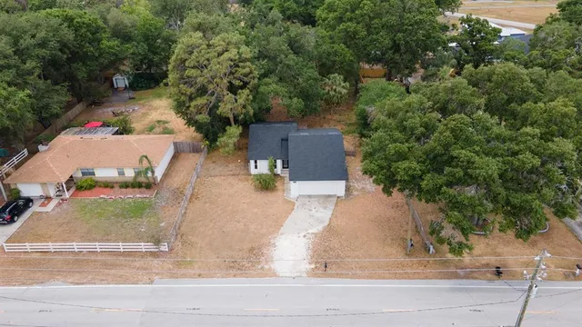 an aerial view of a house with outdoor space