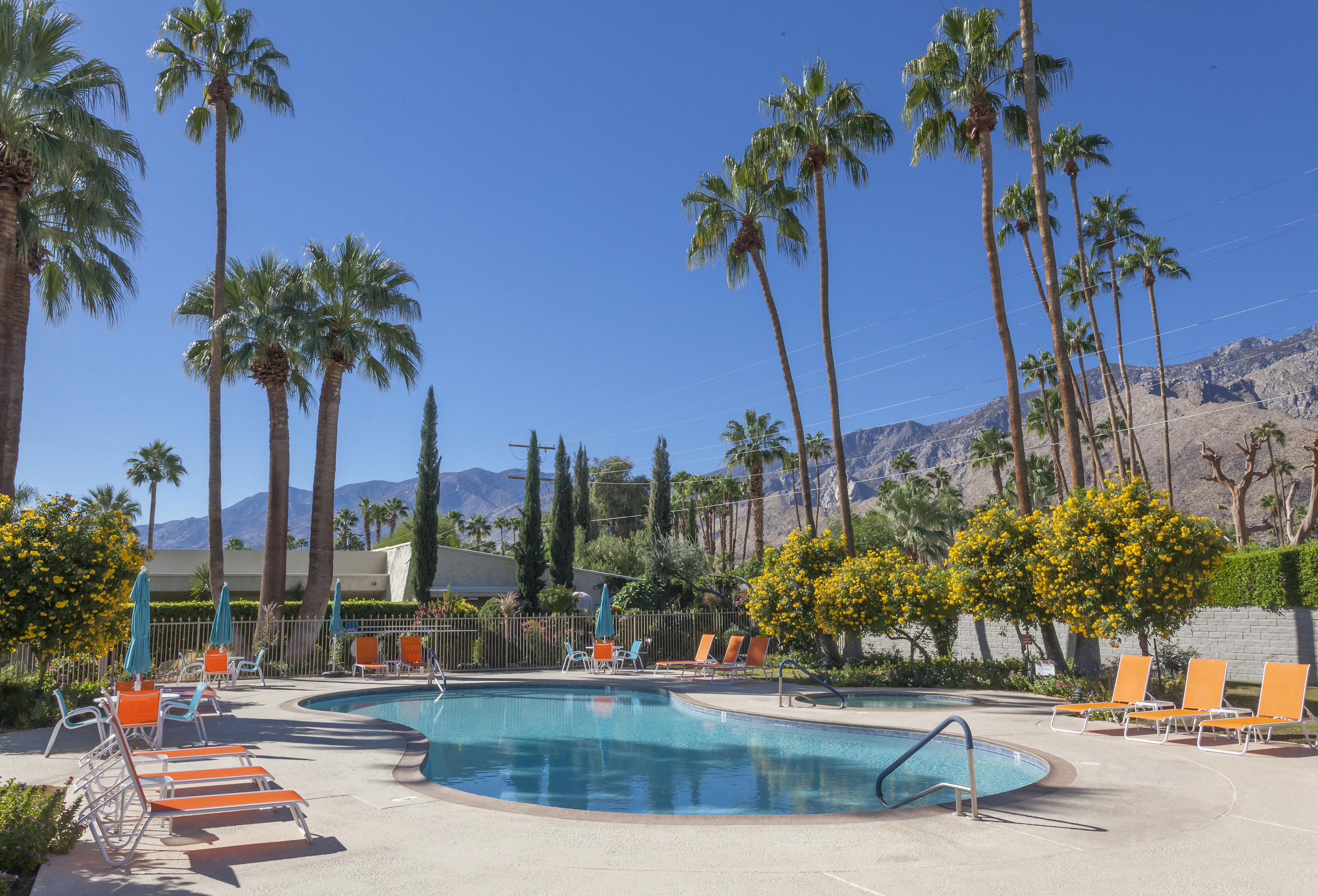 a view of a swimming pool with a table and chairs